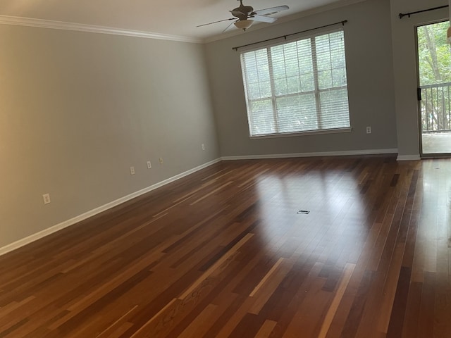 unfurnished room with ornamental molding, dark wood-style flooring, a ceiling fan, and baseboards