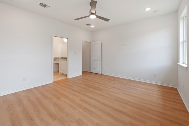 spare room with light hardwood / wood-style flooring and ceiling fan