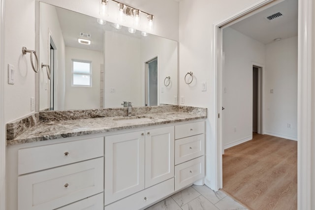 bathroom with vanity and hardwood / wood-style floors