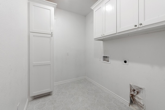 clothes washing area featuring hookup for a washing machine, cabinets, light tile patterned floors, and electric dryer hookup