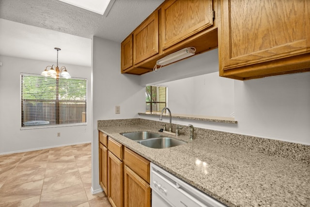 kitchen with a notable chandelier, a textured ceiling, light stone counters, sink, and light tile patterned flooring