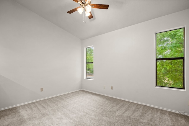 carpeted empty room with vaulted ceiling and ceiling fan