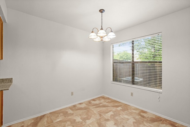 spare room with light tile patterned floors and a notable chandelier