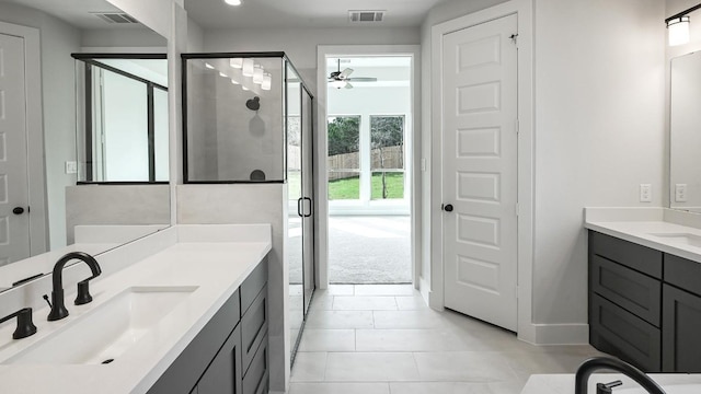 bathroom featuring tile patterned flooring, ceiling fan, a shower with door, and vanity