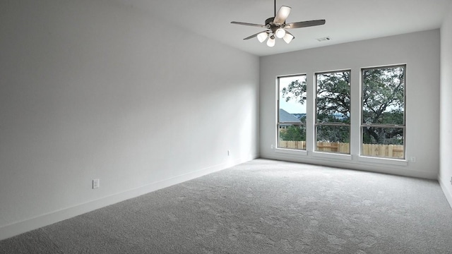 spare room featuring ceiling fan and carpet