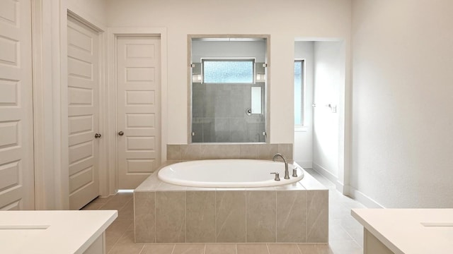 bathroom with plus walk in shower, vanity, and tile patterned floors