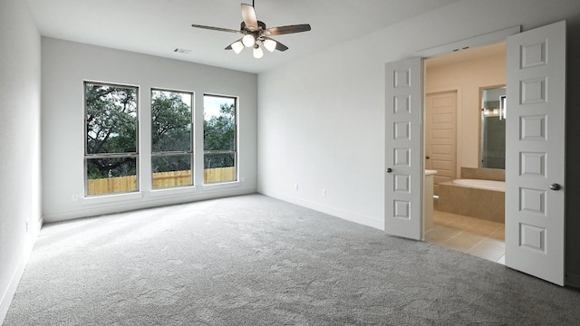 spare room with ceiling fan and light colored carpet