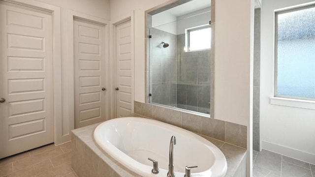 bathroom featuring tile patterned flooring and independent shower and bath