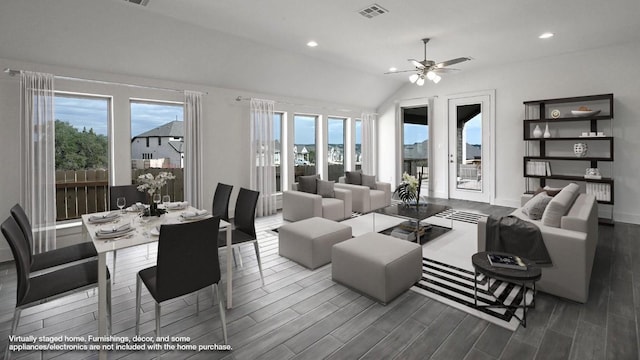 living room featuring a wealth of natural light, ceiling fan, and vaulted ceiling