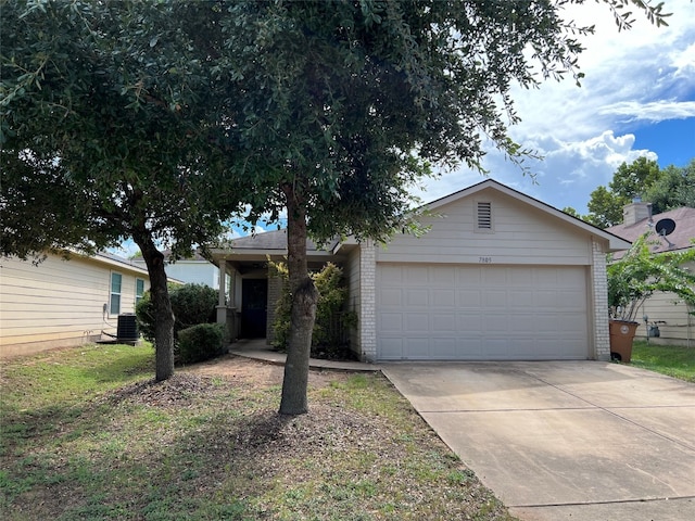 single story home featuring central air condition unit and a garage