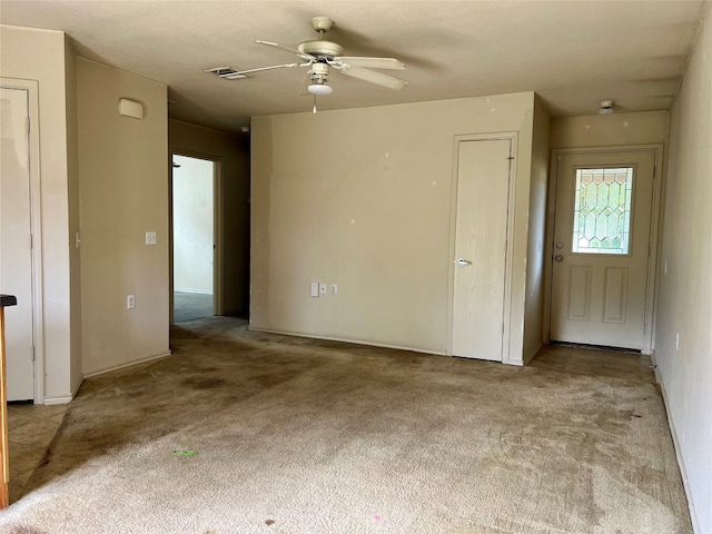 carpeted spare room featuring ceiling fan