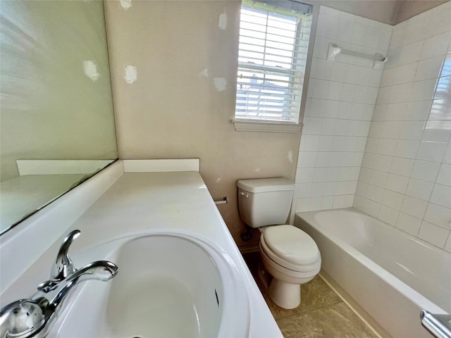 full bathroom with tile patterned floors, vanity, toilet, and tiled shower / bath combo