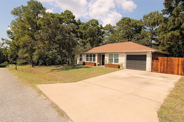 ranch-style home featuring a garage and a front yard