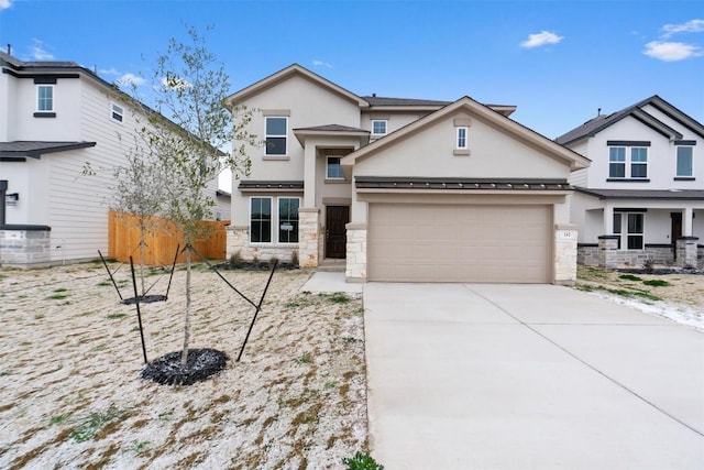 view of front of property with a garage, fence, concrete driveway, stone siding, and stucco siding