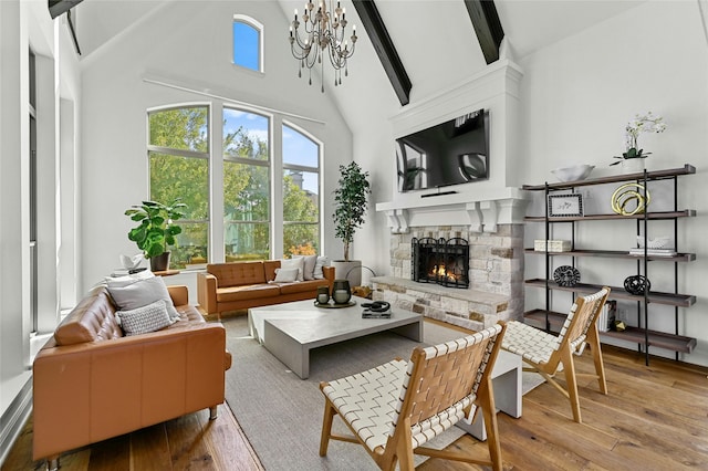 interior space with vaulted ceiling with beams, a fireplace, and a chandelier