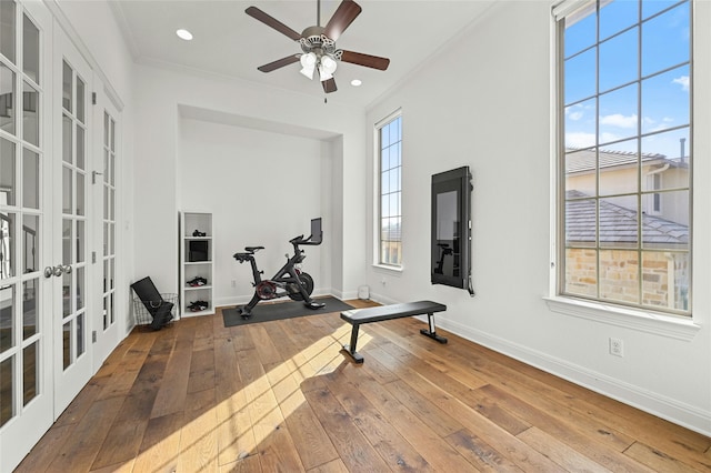 exercise area featuring ceiling fan, hardwood / wood-style floors, crown molding, and french doors