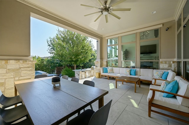 sunroom / solarium featuring ceiling fan