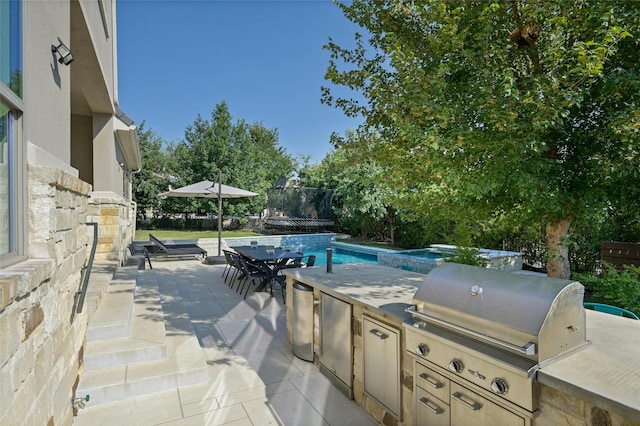 view of patio with exterior kitchen and area for grilling