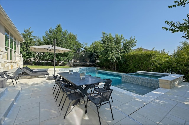 view of pool featuring a patio area and an in ground hot tub