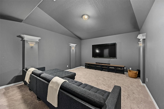 home theater with dark colored carpet, lofted ceiling, and decorative columns