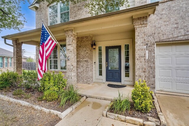 property entrance featuring a porch and a garage