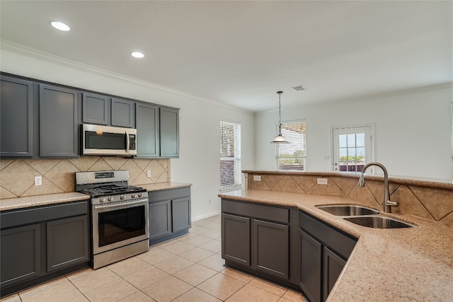 kitchen featuring pendant lighting, light tile patterned floors, sink, stainless steel appliances, and light stone countertops