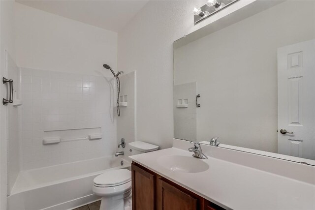 full bathroom with bathing tub / shower combination, vanity, toilet, and tile patterned floors