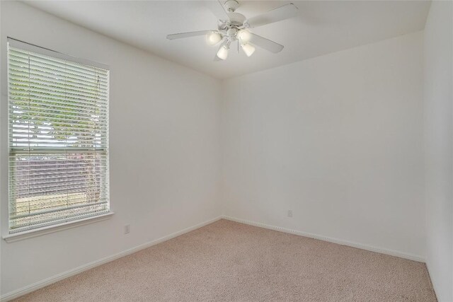 carpeted empty room with ceiling fan