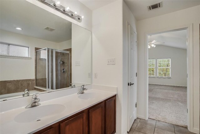 bathroom featuring vaulted ceiling, vanity, independent shower and bath, tile patterned flooring, and ceiling fan