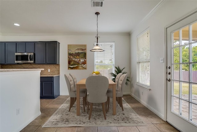 360 Wildhorse Crk, Buda, TX 78610 - dining area featuring healthy amount of natural light, crown molding, light tile patterned flooring, and baseboards