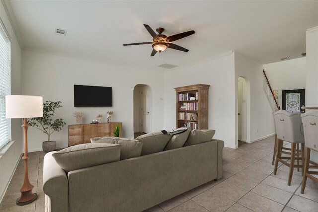 360 Wildhorse Crk, Buda, TX 78610 - living area featuring arched walkways, ceiling fan, light tile patterned floors, and baseboards