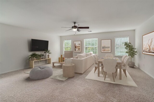 carpeted living room featuring a wealth of natural light and ceiling fan