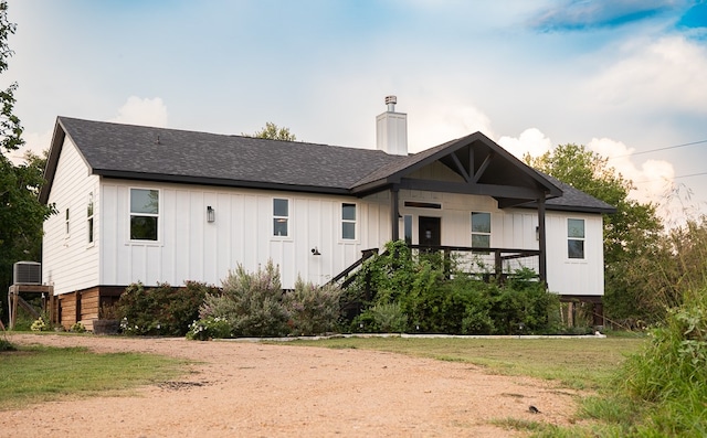 rear view of property with a lawn