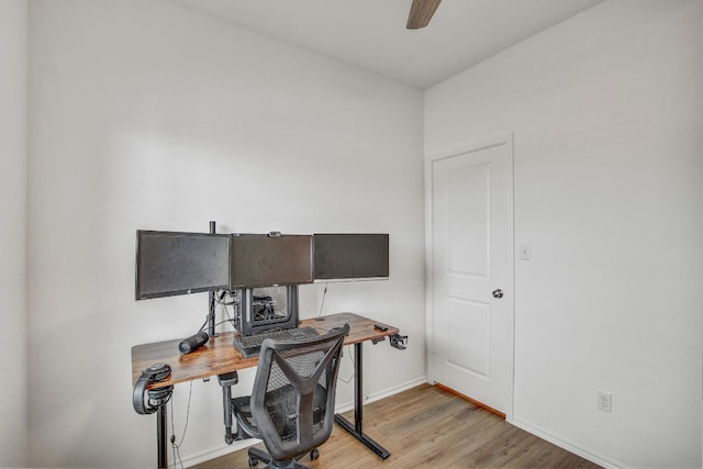 home office with ceiling fan and light hardwood / wood-style floors