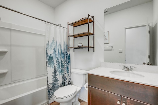 full bathroom with hardwood / wood-style floors, toilet, shower / tub combo, and vanity