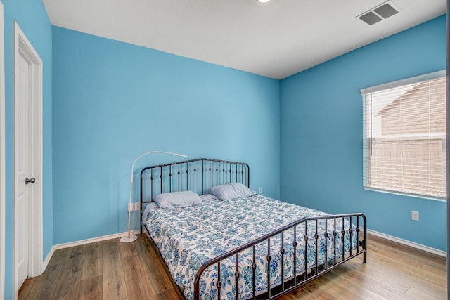 bedroom with wood-type flooring