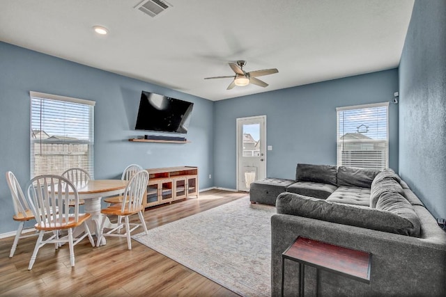 living room with hardwood / wood-style floors and ceiling fan