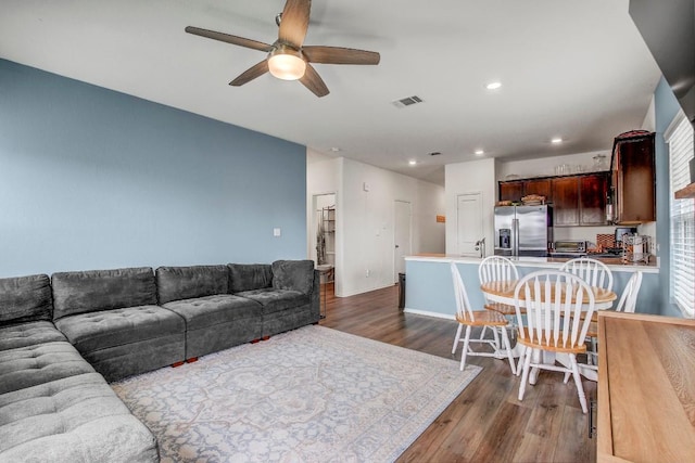 living room with dark hardwood / wood-style flooring, sink, and ceiling fan