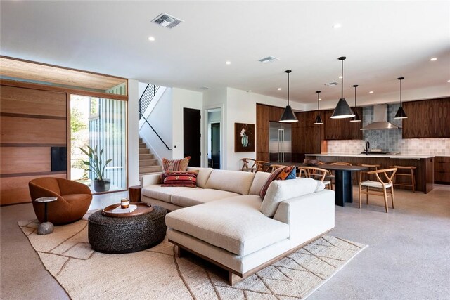 living room with stairway, visible vents, and recessed lighting