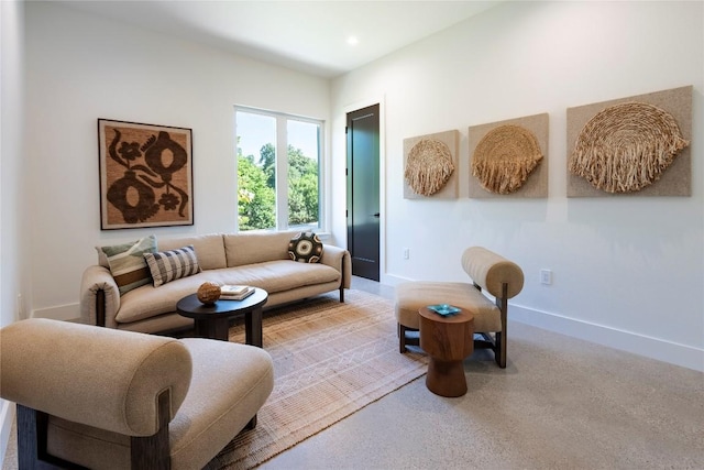 living area featuring recessed lighting and baseboards