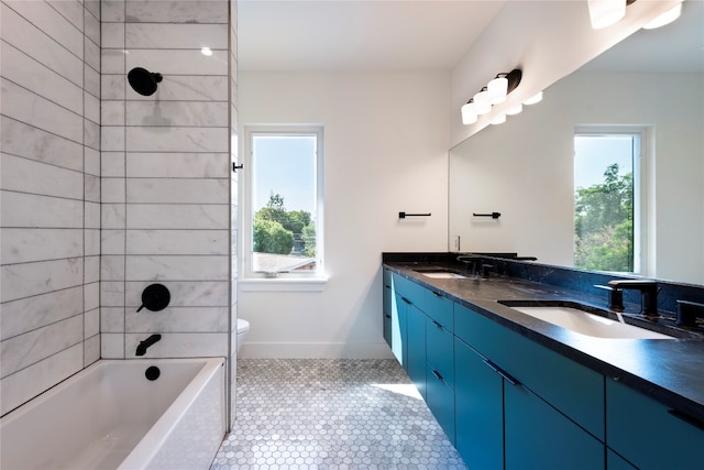 full bathroom featuring tile patterned flooring, toilet, plenty of natural light, and vanity