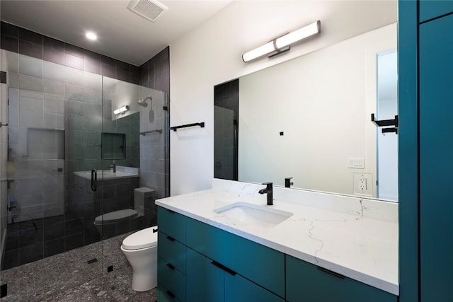 bathroom with toilet, a stall shower, visible vents, and vanity