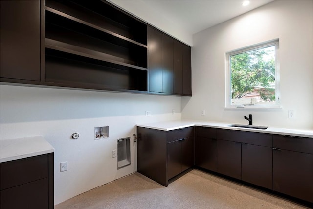 kitchen featuring modern cabinets, light countertops, a sink, and open shelves