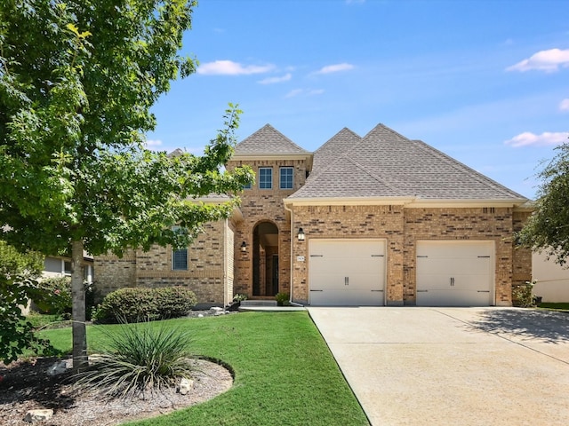 view of front of home featuring a front yard and a garage