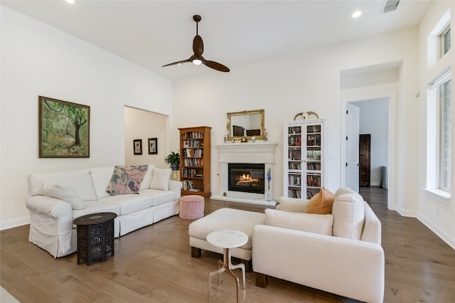 living room featuring ceiling fan, hardwood / wood-style floors, and a healthy amount of sunlight