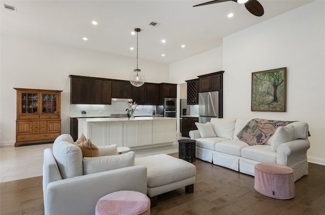 living room featuring light wood-type flooring and ceiling fan