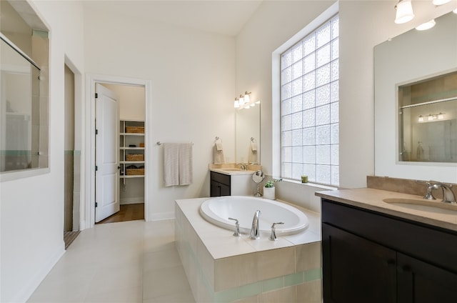 bathroom featuring vanity and separate shower and tub