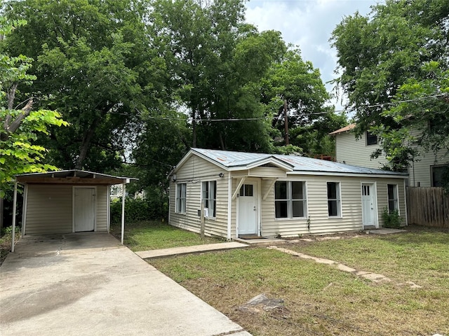 view of front of house with a front yard and a carport