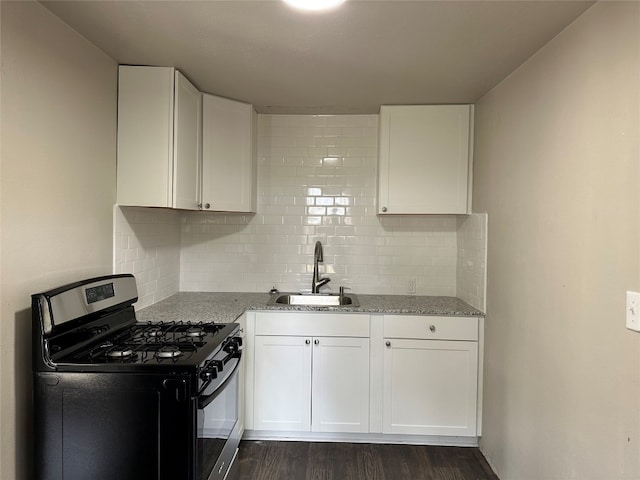 kitchen featuring white cabinets, stainless steel gas range, sink, and dark hardwood / wood-style floors