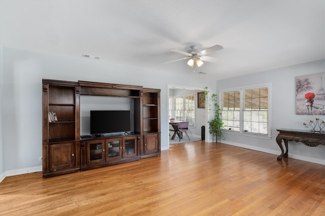 living room featuring light wood-type flooring and ceiling fan